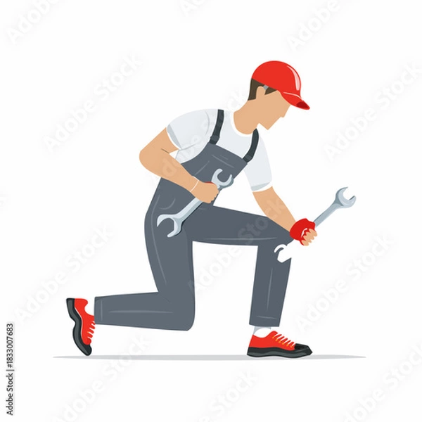 Fototapeta Mechanic kneeling while holding two wrenches in a garage, ready to fix a car with determination and expertise.