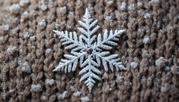 Obraz Close up of a silver snowflake ornament resting on brown knitted fabric