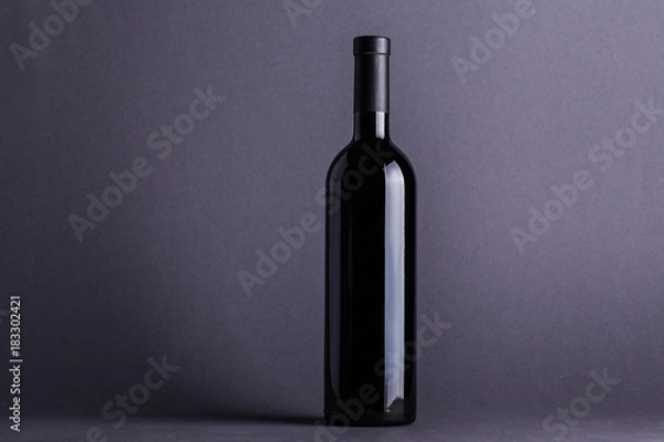 Fototapeta Red wine bottle on grey