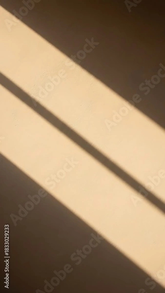 Fototapeta Close-up shot of a wall with a shadow cast by a window, creating a geometric pattern.