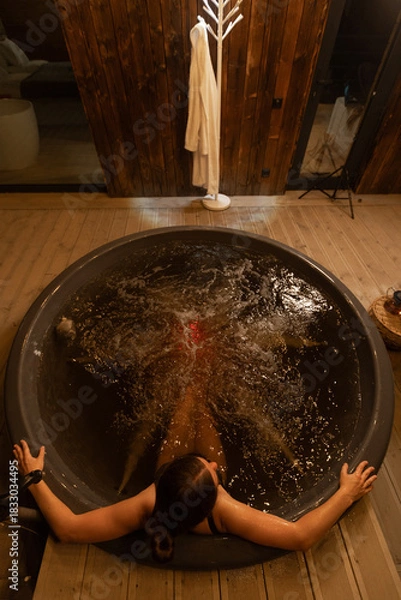 Obraz Relaxing evening in a hot tub by a cozy cabin