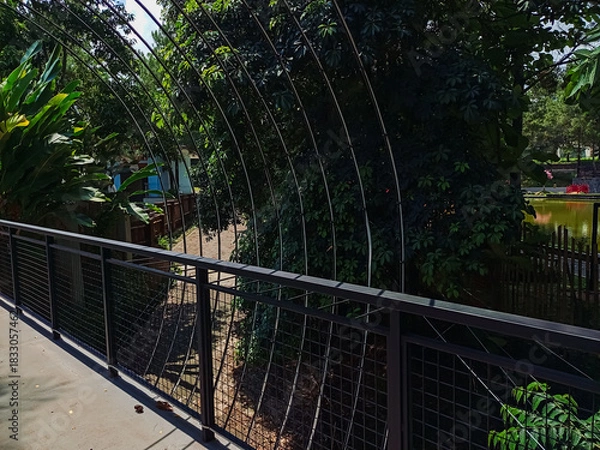 Obraz Modern park bridge and stone stairs with metal mesh railings