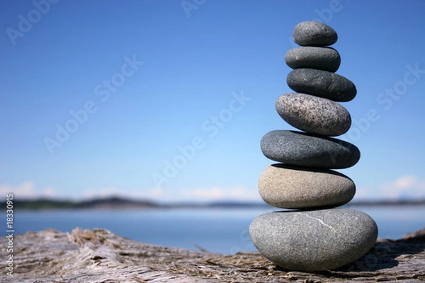 Fototapeta Rocks balancing on log