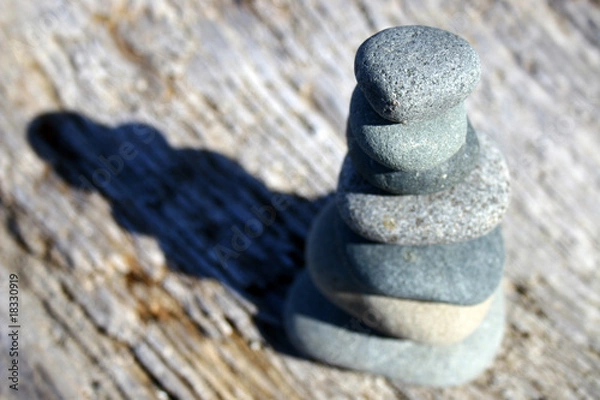 Fototapeta Rocks balancing on log