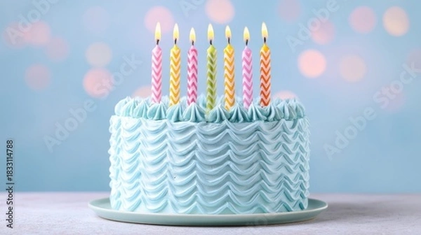 Obraz A light blue frosted cake with wavy ribbed sides sits on a gray cake board,
