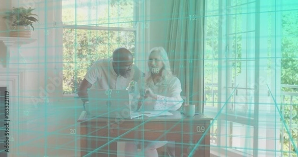 Obraz Reviewing couple in light shirts, pointing at laptop at dining nook with papers and teal grid