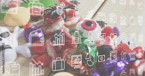 Fototapeta Showing Halloween candy on wood table, with plastic eyes, skull, spider, gummies, analytics overlay