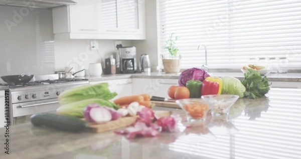Fototapeta Showcasing center cluster of fresh veggies with cutting board, chef knife on polished stone counter