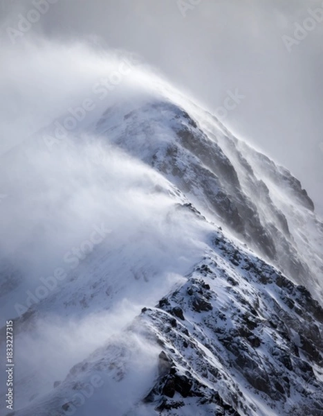 Obraz Dramatic Snowy Mountain Peaks with Wind Blowing Snow and Clouds