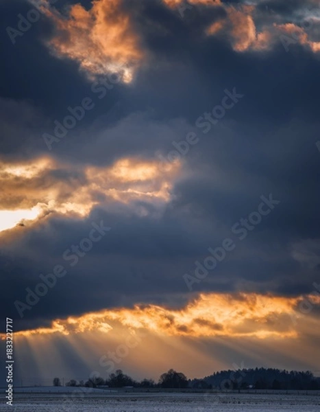Obraz Dramatic Sunset with Dark Clouds and Rays of Light Over Landscape
