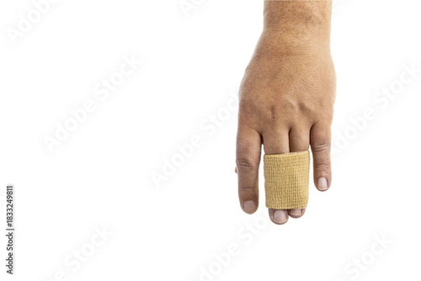 Obraz Close-up of a human hand with a beige elastic bandage wrapped around the middle and ring fingers, isolated on a white background.