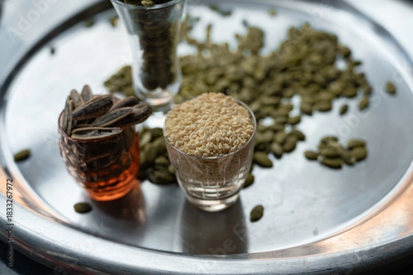 Fototapeta Still life with sunflower, sesame, and pumpkin seeds in glass cups