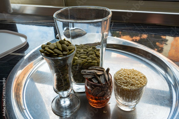 Fototapeta Still life with sunflower, sesame, and pumpkin seeds in glass cups