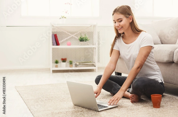Fototapeta Young girl with laptop indoors