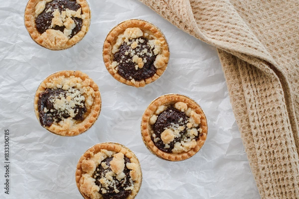 Obraz Overhead view of fresh date tarts arranged on a white surface,