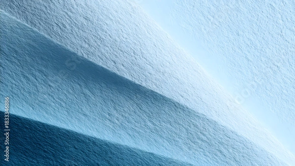 Fototapeta Aerial view of icy terrain with shadows creating a layered effect in shades of blue and white tones