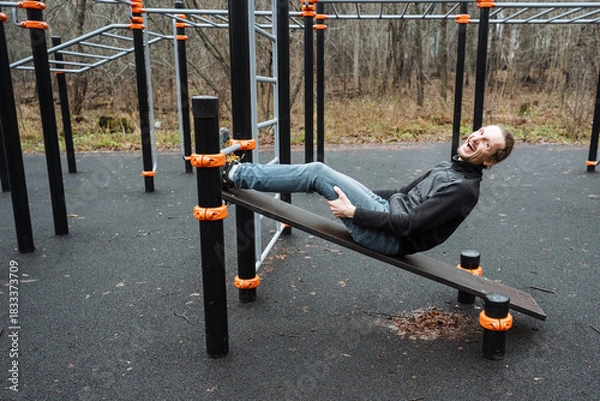 Fototapeta person unwinds after exercise outdoors, individual finds peace outside after physical activity, an individual relaxes peacefully outdoors after completing strenuous fitness routine