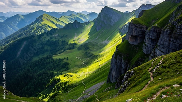 Fototapeta Scenic Alpine Landscape Lush Mountains and Trails under a Cloudy Sky