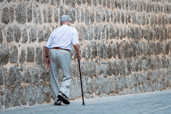 Obraz A man walks slowly down the deserted street.