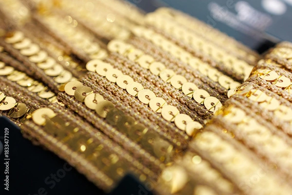 Fototapeta Gold sequin trim close-up with shiny decorative embellishments