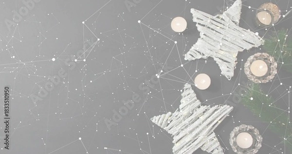 Obraz Glowing twig stars and lit tea lights creating cozy holiday scene on gray tabletop, copy space