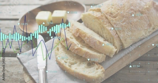 Fototapeta Showing crusty sliced loaf on wooden board at table, with butter dish, knife and chart overlay