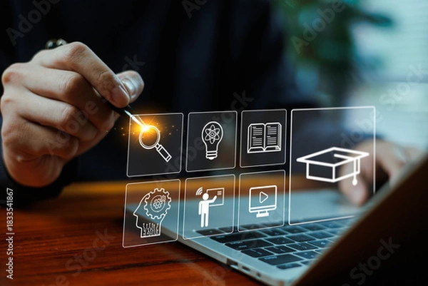 Fototapeta Digital e-learning interface with hand selecting online education icons, representing innovation, knowledge, virtual study, and modern learning technology for training and academic development.