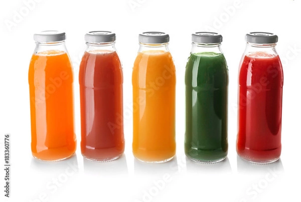 Fototapeta Bottles with juices on white background