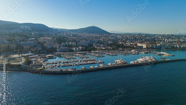 Obraz Kusadasi, Turkey. Aerial shot of Setur Marina packed with dozens of moored yachts. Summer morning view of the dense boat concentration against cityscape.. Aerial View
