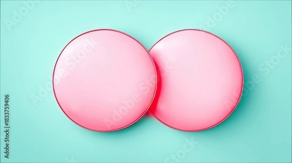 Fototapeta Two pink circles overlapping against a turquoise background, shot from above. The image is clean and minimalist.