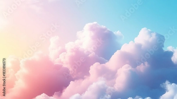Fototapeta Pastel colored clouds against a light blue sky at sunset time