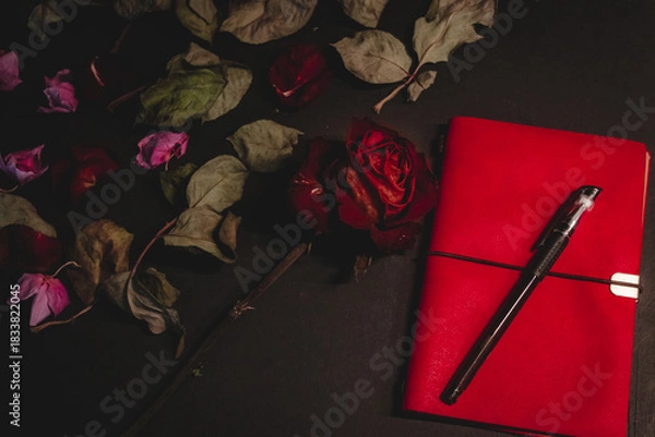 Obraz Dried red rose, notebook, pen symbolizing lost love