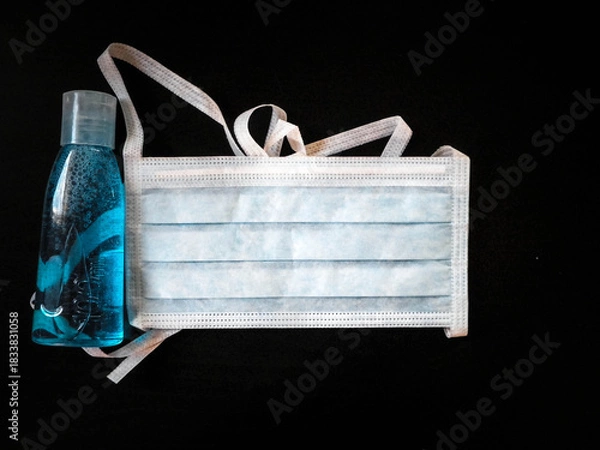 Fototapeta Antibacterial fluid and mask. Coronavirus protection kit.