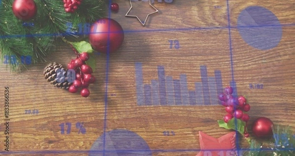 Obraz Displaying holiday wooden tabletop with blue data overlays, evergreen sprig, red baubles, pinecone