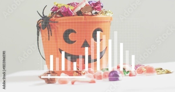 Obraz Sitting orange pumpkin bucket holding wrapped candy, gummies, black spider on white table, graph
