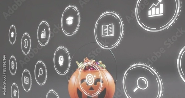 Fototapeta Displaying carved jack-o-lantern candy container with wrapped candies on table, hologram icons