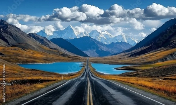 Fototapeta Majestic mountains rise in the distance, framed by a clear sky.