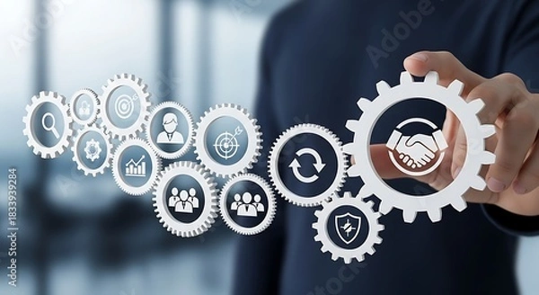 Obraz Hand holding a gear with handshake icon, illustrating business process integration and collaborative solutions