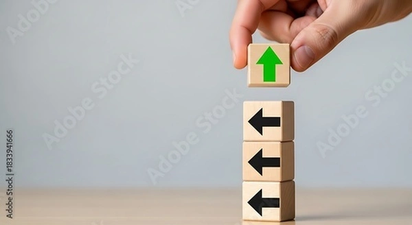 Obraz Hand selecting a wooden block with green arrow pointing up, representing a different business strategy