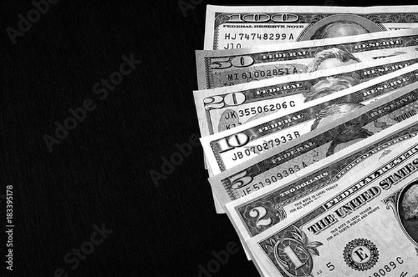 Obraz Us dollars on black board background black and white.