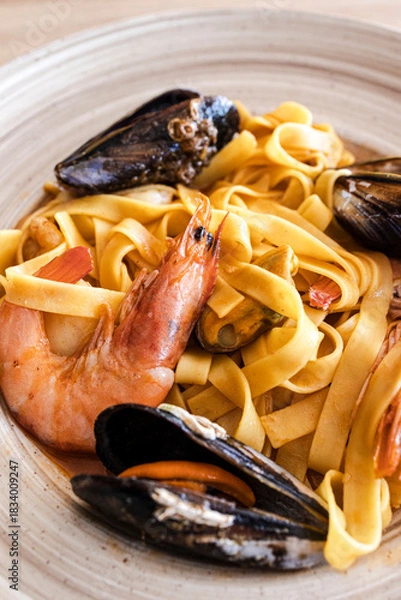 Obraz Seafood pasta with shrimp and mussels on a plate