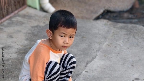 Fototapeta portrait of a little boy, Sitting bored