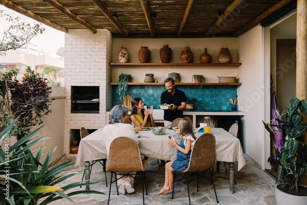 Obraz Family dinner on outdoor kitchen terrace