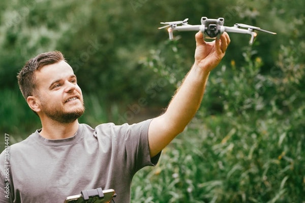Fototapeta Young man demonstrating drone for UAV lessons