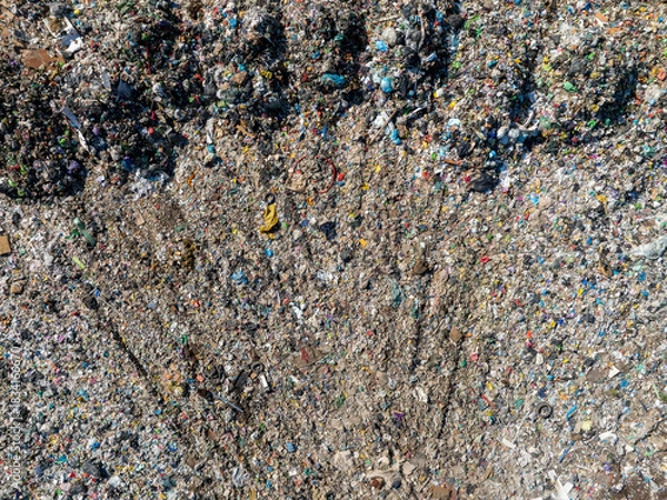 Fototapeta Aerial view of a landfill filled with large amounts of mixed household and plastic waste.