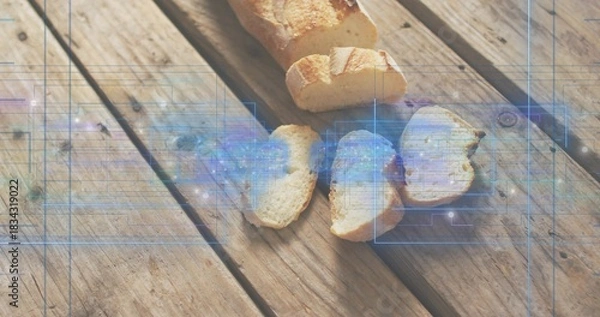Fototapeta Displaying partially sliced crusty baguette with three slices on picnic table, blue HUD overlay