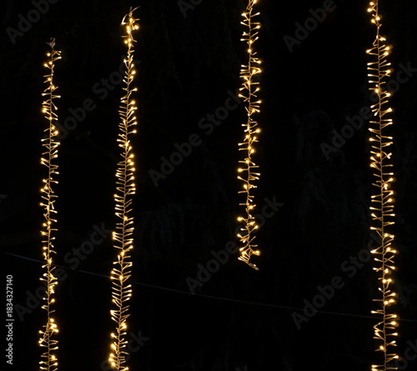 Obraz Background of Vertical Christmas Lights Hanging in the dark