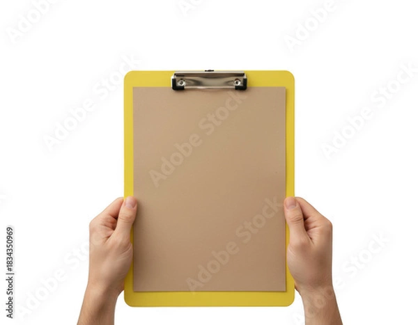 Obraz Hands Holding a Yellow Clipboard with Blank Brown Paper Against a Dark Void