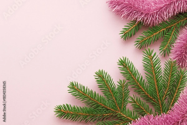 Fototapeta Pink Christmas background with fir branches and tinsel, copy space