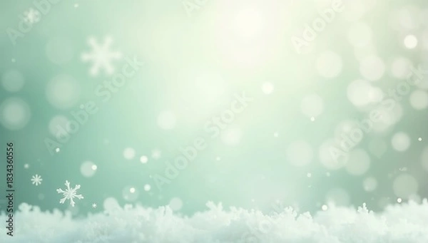 Fototapeta A serene winter background featuring delicate white snowflakes and a snowy foreground against a mint green soft glow.